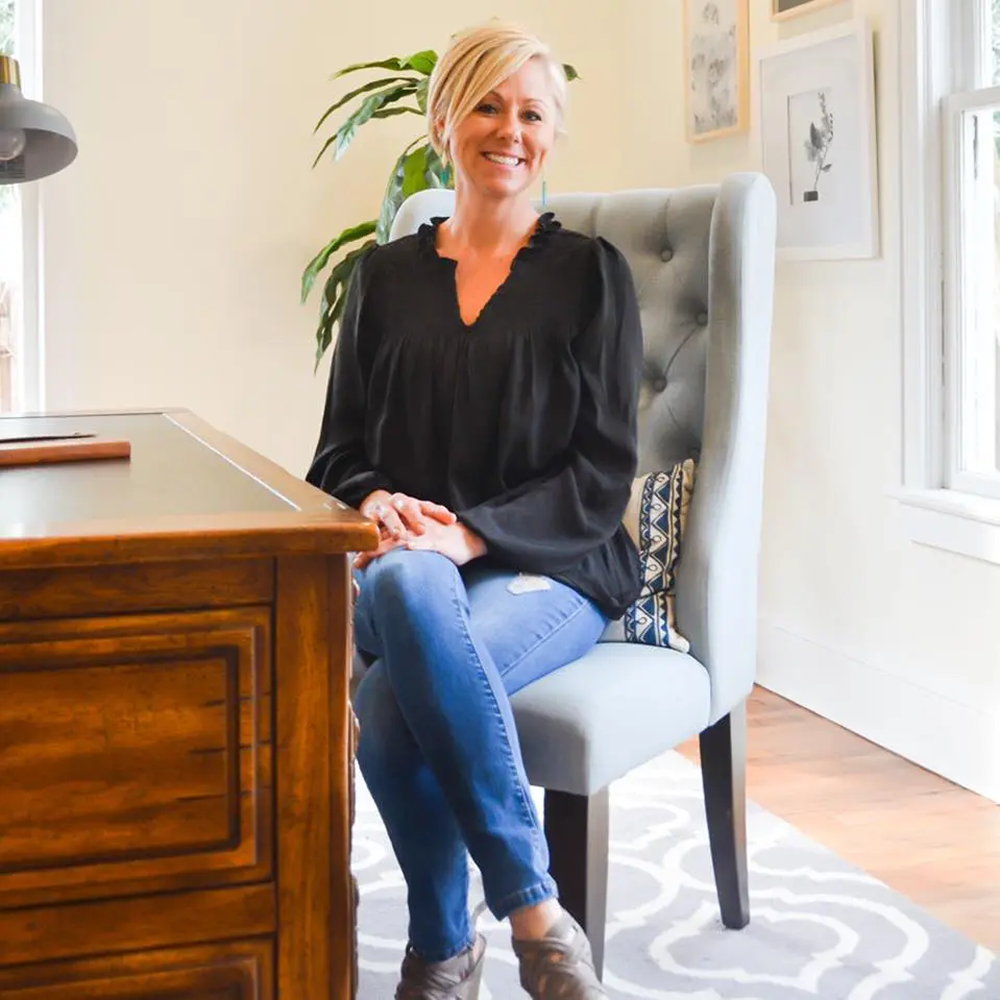 Woman sitting in a home office chair.