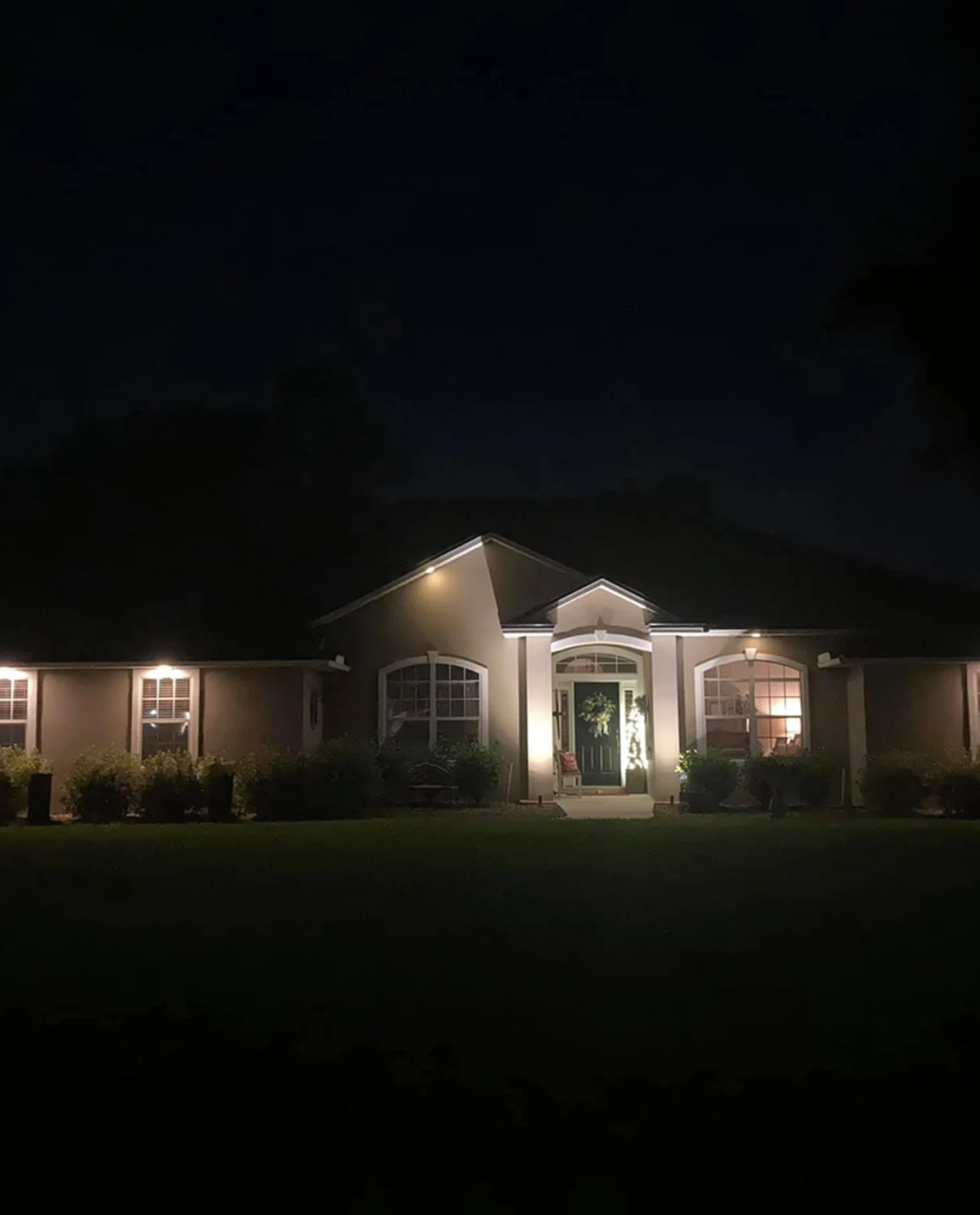 Illuminated house exterior at night.