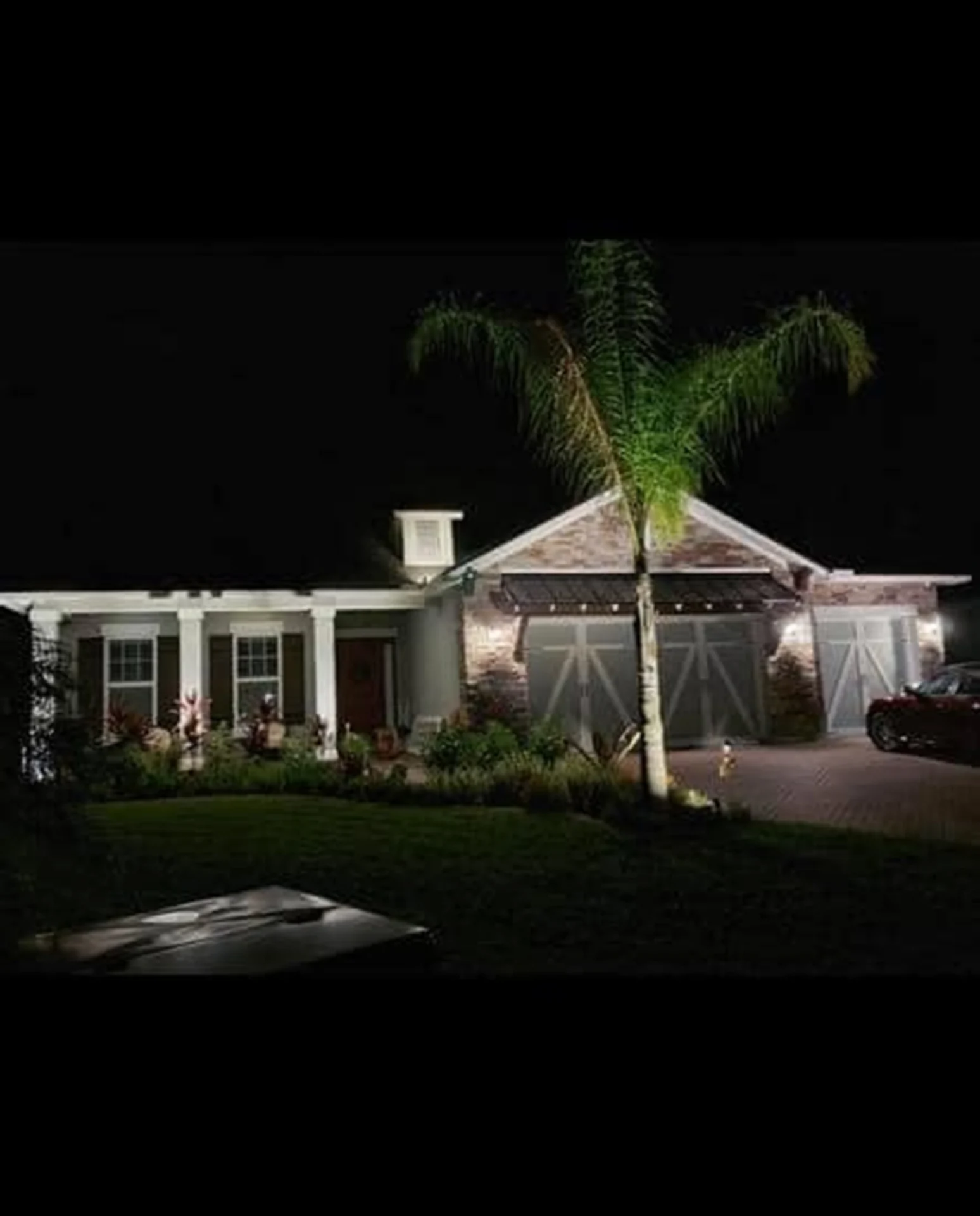 Night view of illuminated suburban house exterior.